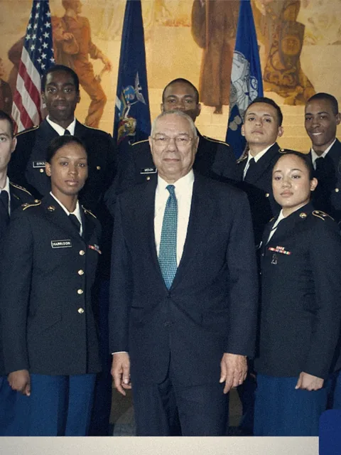 Colin Powell standing with Army ROTC cadets